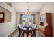 Inviting dining room features a chandelier, wood table, and view through the window at 2350 Laurel Pointe Ln, Lawrenceville, GA 30043