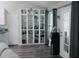 Dining room or kitchen area featuring a built-in glass door cabinet, a door to the outside, and vinyl floors at 2350 Laurel Pointe Ln, Lawrenceville, GA 30043