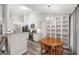 An eat-in kitchen with bright lighting, white cabinets, and black appliances at 2350 Laurel Pointe Ln, Lawrenceville, GA 30043