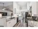A bright kitchen featuring white cabinets, black appliances, and an eat-in bar at 2350 Laurel Pointe Ln, Lawrenceville, GA 30043