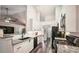 Modern kitchen features white cabinets, granite counters, stainless steel appliances, and stylish backsplash at 2350 Laurel Pointe Ln, Lawrenceville, GA 30043