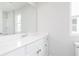 Bright bathroom with white cabinets, large mirror, and tile floor at 3021 Cambridge Mill St, Acworth, GA 30102