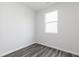 A bright, airy bedroom boasts a large window, neutral walls, and contemporary gray flooring at 3021 Cambridge Mill St, Acworth, GA 30102