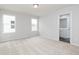 Bright bedroom with large windows, neutral walls, carpet flooring, and an attached bathroom at 3021 Cambridge Mill St, Acworth, GA 30102