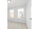 Bright bedroom featuring neutral carpet, two windows, and light grey walls at 3021 Cambridge Mill St, Acworth, GA 30102