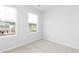 Neutral bedroom featuring carpeted floors, white walls, and two windows at 3021 Cambridge Mill St, Acworth, GA 30102