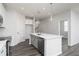 Bright kitchen features a central island with stainless steel appliances and modern pendant lighting at 3021 Cambridge Mill St, Acworth, GA 30102