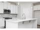 Stylish kitchen featuring white cabinets, a gray backsplash, and an island with pendant lights at 3021 Cambridge Mill St, Acworth, GA 30102