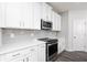 Modern kitchen with white cabinets, stainless steel appliances, and stylish gray backsplash at 3021 Cambridge Mill St, Acworth, GA 30102