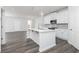 Modern, open-concept kitchen featuring a large island, pendant lighting, and white cabinetry at 3021 Cambridge Mill St, Acworth, GA 30102