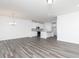 Open-concept living room featuring a kitchen with white cabinets and an island with pendant lights at 3021 Cambridge Mill St, Acworth, GA 30102