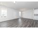 Open-concept living space with a view of the kitchen, featuring sleek flooring and ample natural light at 3021 Cambridge Mill St, Acworth, GA 30102