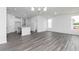 Bright, open living space featuring modern finishes, a kitchen island, and stylish pendant lighting at 3021 Cambridge Mill St, Acworth, GA 30102