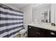 Bathroom with a vanity, sink, toilet, and a shower with a stylish striped curtain at 577 Joneus Dr, Mcdonough, GA 30252
