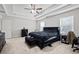 Large bedroom boasts tray ceiling, a ceiling fan and two large windows for plenty of natural light at 577 Joneus Dr, Mcdonough, GA 30252