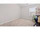 Neutral bedroom featuring plush carpeting, bright natural light, and ample space for storage at 577 Joneus Dr, Mcdonough, GA 30252