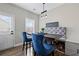 Charming dining area features a pendant light, two stylish blue chairs, and a padded bench at 577 Joneus Dr, Mcdonough, GA 30252