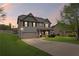Dusk view of a charming two-story home with a well-maintained lawn and a two-car garage at 577 Joneus Dr, Mcdonough, GA 30252