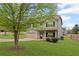 Two-story home with a well-maintained lawn and a two-car garage, featuring a mature shade tree at 577 Joneus Dr, Mcdonough, GA 30252