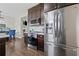 Eat in Kitchen with marble countertop, dark cabinets and stainless steel appliances at 577 Joneus Dr, Mcdonough, GA 30252