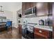 Modern kitchen features stainless steel appliances, white subway tile backsplash and dark brown cabinetry at 577 Joneus Dr, Mcdonough, GA 30252
