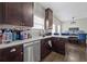 Eat in Kitchen with marble countertop, dark cabinets and stainless steel appliances at 577 Joneus Dr, Mcdonough, GA 30252
