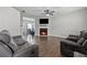 Cozy living room features a fireplace, hardwood floors and comfortable seating at 577 Joneus Dr, Mcdonough, GA 30252