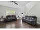 Bright living room with hardwood floors, a staircase and a view to the front entry at 577 Joneus Dr, Mcdonough, GA 30252