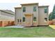 Exterior view of a home's backyard with a patio and lawn at 1205 Apple Blossom Dr, Cumming, GA 30041