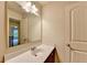Bathroom featuring a single sink, dark wood vanity, mirror, and door at 1205 Apple Blossom Dr, Cumming, GA 30041
