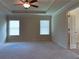 Spacious bedroom features carpet, recessed tray ceiling, ceiling fan, and natural light at 1205 Apple Blossom Dr, Cumming, GA 30041