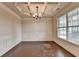 Elegant dining room with a coffered ceiling, wainscoting, hardwood floors, and a large window at 1205 Apple Blossom Dr, Cumming, GA 30041