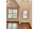 Inviting entryway with hardwood floors, a large window, and a bright white front door at 1205 Apple Blossom Dr, Cumming, GA 30041