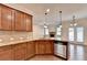 Charming kitchen features granite countertops, tile backsplash, stainless steel appliances, and a view to the living room at 1205 Apple Blossom Dr, Cumming, GA 30041