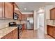 Well-appointed kitchen features granite counters, stainless steel appliances, and wood cabinetry at 1205 Apple Blossom Dr, Cumming, GA 30041