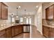 Charming kitchen features granite countertops, tile backsplash, stainless steel appliances, and wood flooring at 1205 Apple Blossom Dr, Cumming, GA 30041