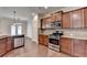 Kitchen featuring stainless steel oven and microwave and granite countertops with eat-in space at 1205 Apple Blossom Dr, Cumming, GA 30041
