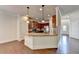 Open-concept kitchen with granite countertops, stainless steel appliances, and hardwood floors at 1205 Apple Blossom Dr, Cumming, GA 30041