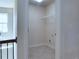 Upstairs laundry room features tile floors, hookups, and wire shelving at 1205 Apple Blossom Dr, Cumming, GA 30041