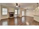 Bright living area features wood floors, fireplace, ceiling fan, and doors to the outdoor space at 1205 Apple Blossom Dr, Cumming, GA 30041