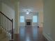 Open-concept living room featuring a stone fireplace and staircase at 1205 Apple Blossom Dr, Cumming, GA 30041