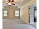 Spacious main bedroom featuring tray ceilings, ceiling fan, and access to en suite bath at 1205 Apple Blossom Dr, Cumming, GA 30041