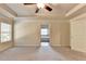 Spacious main bedroom with a ceiling fan, plush carpet, and a doorway to the ensuite bathroom at 1205 Apple Blossom Dr, Cumming, GA 30041
