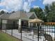 Community pool features lounge chairs, umbrellas, a fenced in area, and a pool house, perfect for relaxation and recreation at 1205 Apple Blossom Dr, Cumming, GA 30041