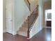 Carpeted staircase with wooden banister and iron spindles, leading to the upper level of the home at 1205 Apple Blossom Dr, Cumming, GA 30041