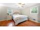 Comfortable bedroom features a queen-sized bed, wood floors, and a neutral color scheme at 2240 Murdock Rd, Marietta, GA 30062
