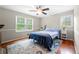 Cozy bedroom with warm wood floors, fresh paint, ceiling fan, and a large window at 2240 Murdock Rd, Marietta, GA 30062