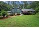Charming two-story home with green lawn, classic shutters and beautiful, mature landscaping at 2240 Murdock Rd, Marietta, GA 30062