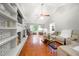 Inviting living room with vaulted ceiling, hardwood floors, and bright, white painted brick fireplace at 2240 Murdock Rd, Marietta, GA 30062