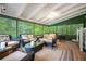 Screened-in porch with cozy wicker seating and views of lush greenery at 2240 Murdock Rd, Marietta, GA 30062